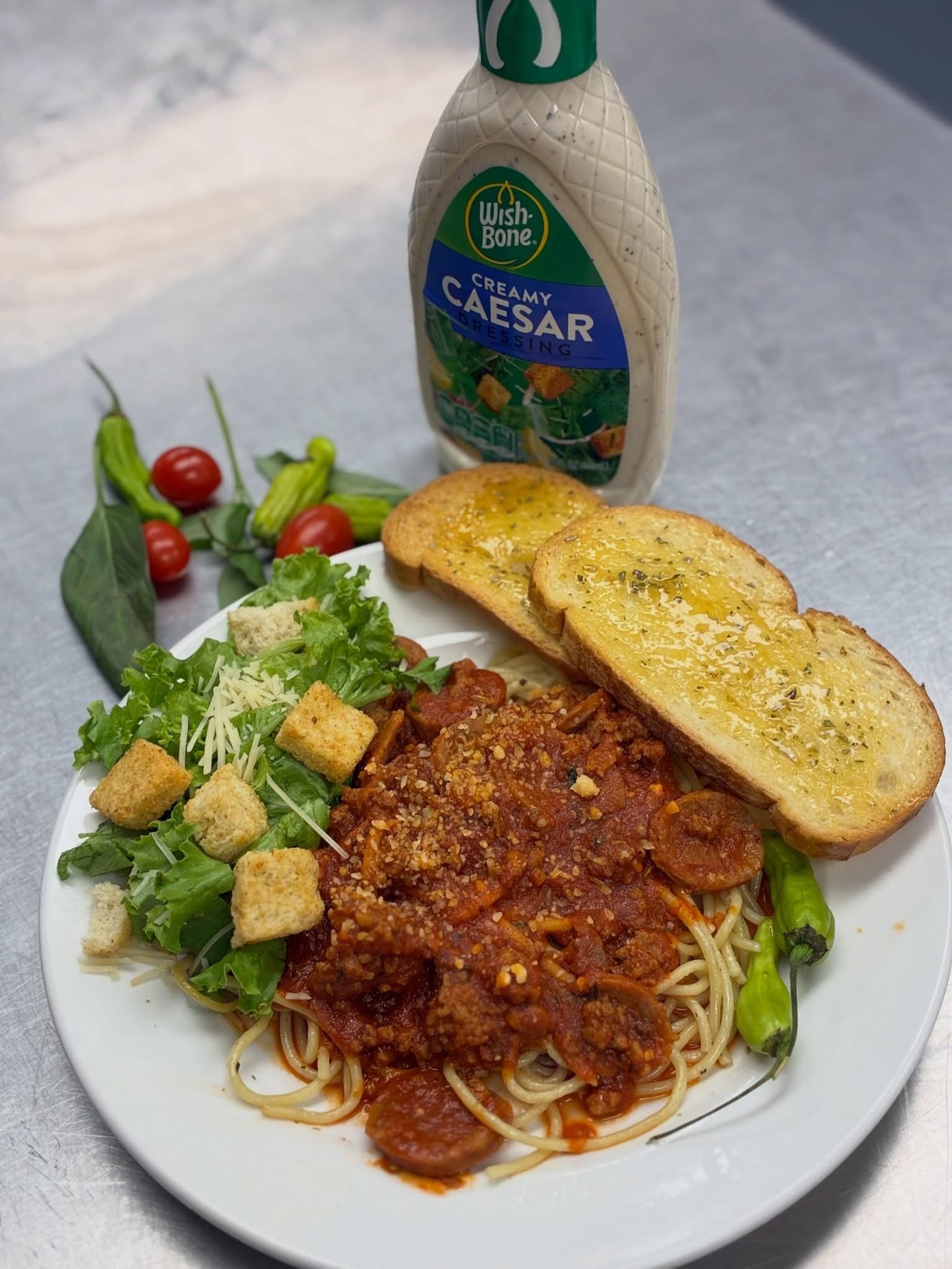 Spaghetti plate with garlic bread and caesar salad